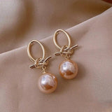 Boucles d'oreilles perle rose et nœud