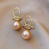Boucles d'oreilles perle rose et nœud