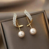 Boucles d'oreilles perle et arc de zircones