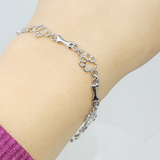 Bracelet à pendentifs pattes de chien et os en or blanc