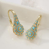 Cluster de puces d'oreilles doré avec turquoise