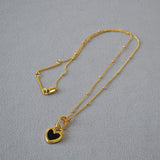 Collier pendentif cœur noir et blanc en or