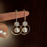 Boucles d'oreilles perle et disque de zircones