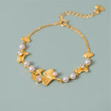 Bracelet doré feuilles de ginkgo et marguerites