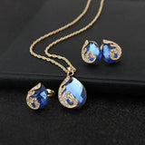 Ensemble : collier et boucles d'oreilles cristal bleu en or