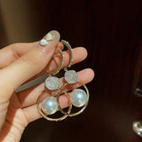 Boucles d'oreilles perle et disque de zircones